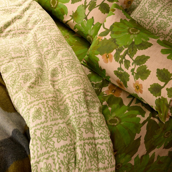 Green floral-patterned fabric draped over a surface