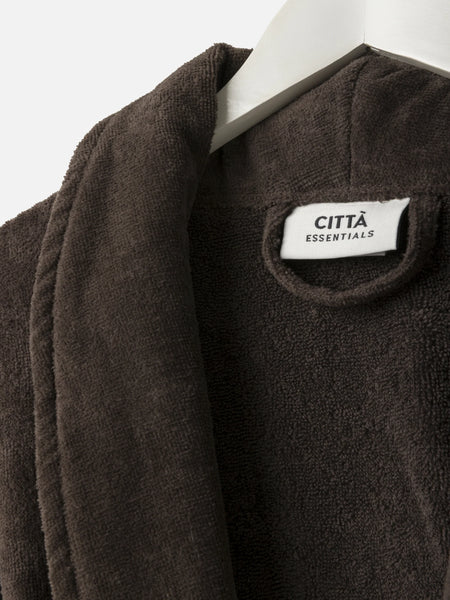 Brown jacket with a visible 'Citta Essentials' label on a white background